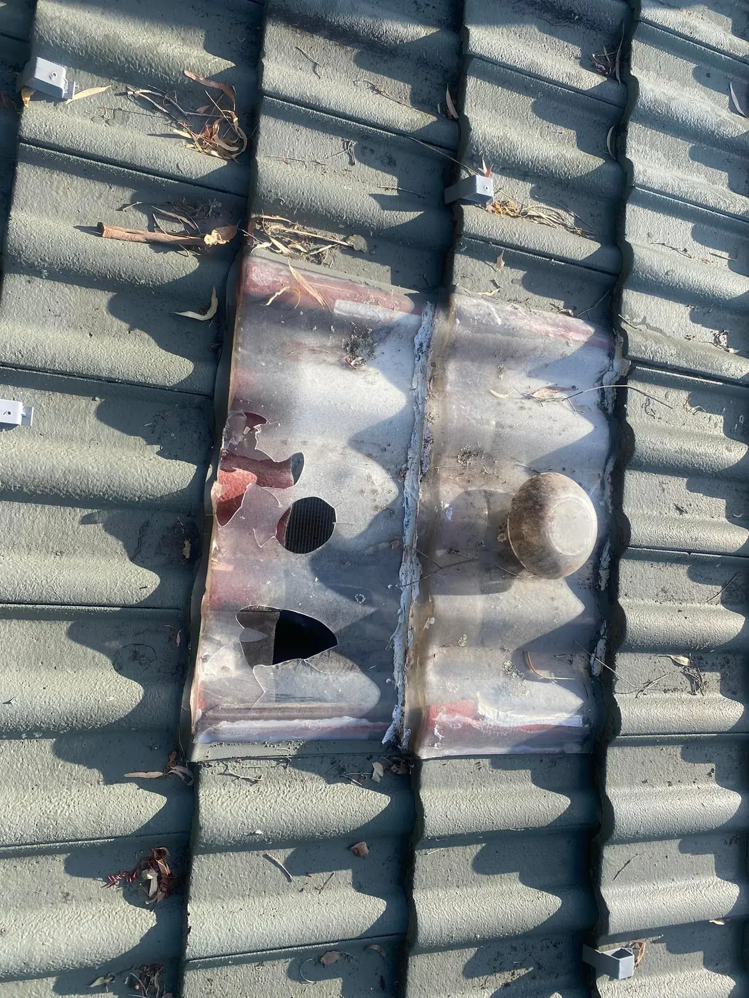 Close-up of damaged concrete roof tiles with the broken area exposed